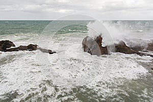 Waves hitting a sea rock with great force