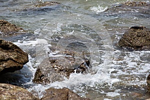 The waves knocked the rocks. photo