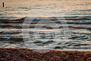 Waves of Lake Michigan on the beach at sunset in South Haven Michigan