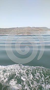 Waves in Lake with mountain in background