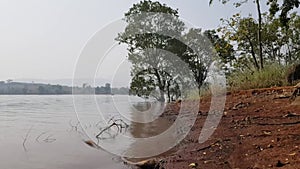 Waves on the lake side. Pan shot gently moving from the waves to the sky