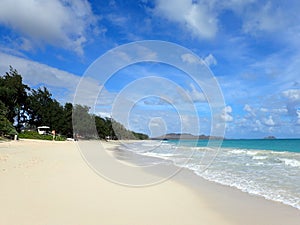 Waves lap on shore with Lifeguard Tower on Waimanalo Beach photo