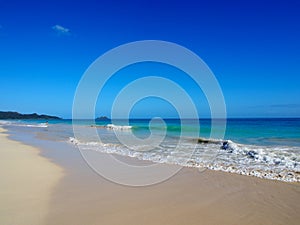 Waves lap on shore of Waimanalo Beach photo