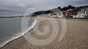 Waves lapping the shore Lyme Regis beach Dorset England UK