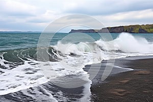 waves lapping volcanic lake shore during a windy day