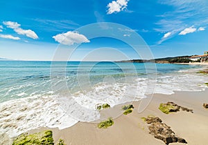 Waves in Le Bombarde beach under clouds