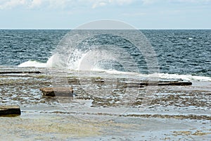 Waves on limetone beach photo