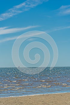 Waves at LLansteffan beach with clear blue water in southern Wales