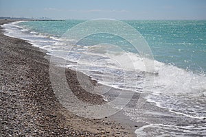 waves on mediterranean sea with pebble beach