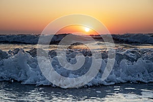 Waves of the Mediterranean Sea with sea foam and spray. Beautiful sea on sunset background. Sundown. Seascape. Running