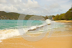 Waves meeting a pristine beach in the windward islands