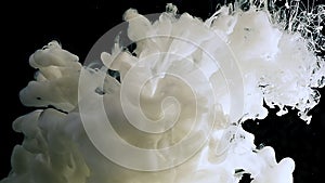 Waves of milky ink and splashes of white paints in the water. White abstract background