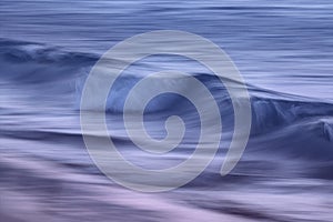 Waves on the ocean captured with a slow shutter speed photo