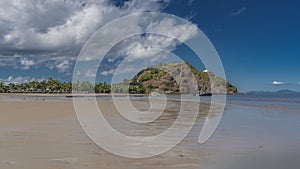 The waves of the ocean spread over the sandy beach.