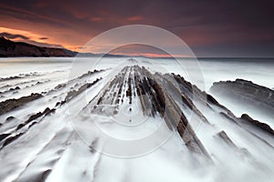 Waves over the flysch at sunset