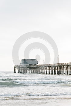 Waves in the Pacific Ocean and the pier in Newport Beach, Orange County, California