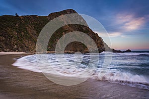 Waves in the Pacific Ocean and a rocky bluff at Pfeiffer Beach