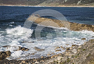 Waves and pier at Sennen Cove in Cornwall.