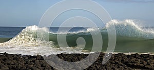 Waves pounding on basalt rocks at Ocean Beach Bunbury Western Australia