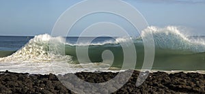 Waves pounding on basalt rocks at Ocean Beach Bunbury Western Australia photo