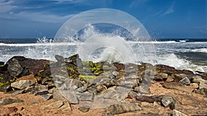 Waves pounding rocks on a beach