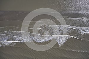 Waves reaching the coast and breaking on sand bank