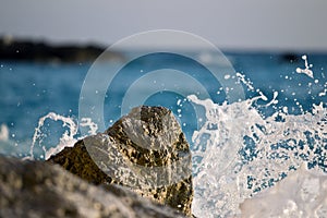 A wave that hits a rock photo