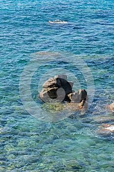 Waves on rocky beach, sea shore with waves crushing over the big rocks