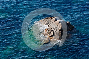 Waves on rocky beach, sea shore with waves crushing over the big rocks