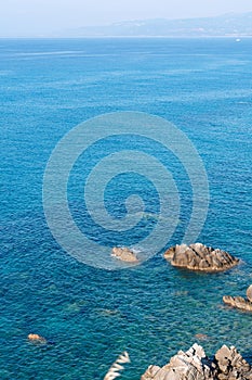 Waves on rocky beach, sea shore with waves crushing over the big rocks