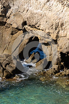 Waves on rocky beach, sea shore with waves crushing over the big rocks