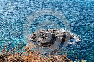 Waves on rocky beach, sea shore with waves crushing over the big rocks