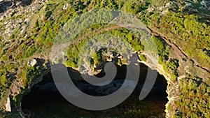 Waves Between The Rocky Cliffs Of Hole - aerial ascend