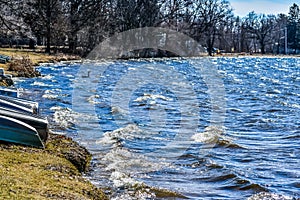 Waves Rolling Onto Shoreline with Boats