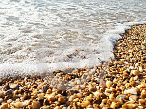 Waves rolling on a pebble beach, beautiful landscape.