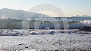 Waves rolling on a pebble sand beach