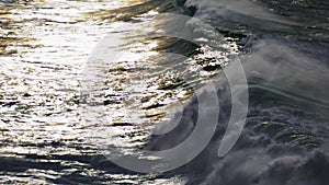 Waves rolling shiny surface in super slow motion. Powerful sea surf barreling