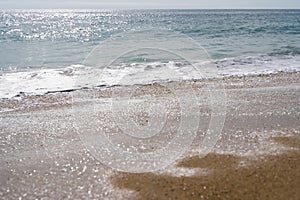 Waves and sand on sunny day in Algarrobo beach photo