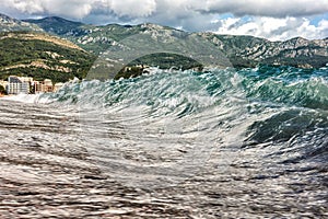 Waves in the sea in sandy beach at resort Becici in Montenegro