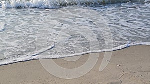 Waves on sea shore on sandy beach