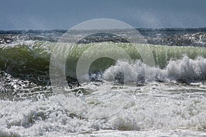 Waves in Shades of Blue, White, and Green Crashing on a Beach