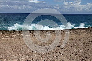 Waves shattering onto rocky Caribbean coast