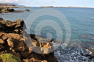 Waves smash under coastline