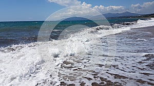 Waves splash foam in summer sea Preveza Greece