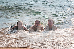 Waves Splash Girls Laying on the Sand