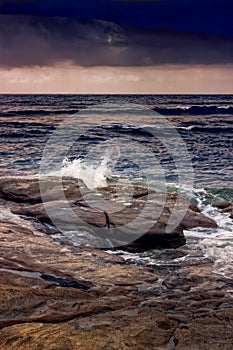 Waves Splash On The Rocks At Sunset