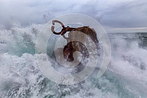 Waves splashing against El peine Del Viento photo