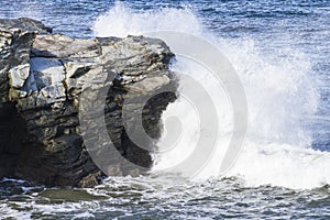 Waves splashing against rock