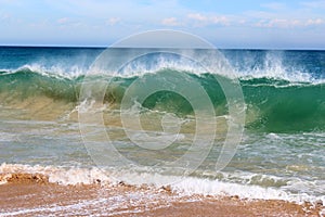 Waves splashing on basalt rocks at Ocean beach Bunbury Western Australia photo