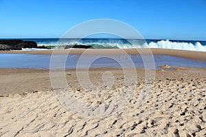 Waves splashing on basalt rocks at Ocean beach Bunbury Western Australia photo